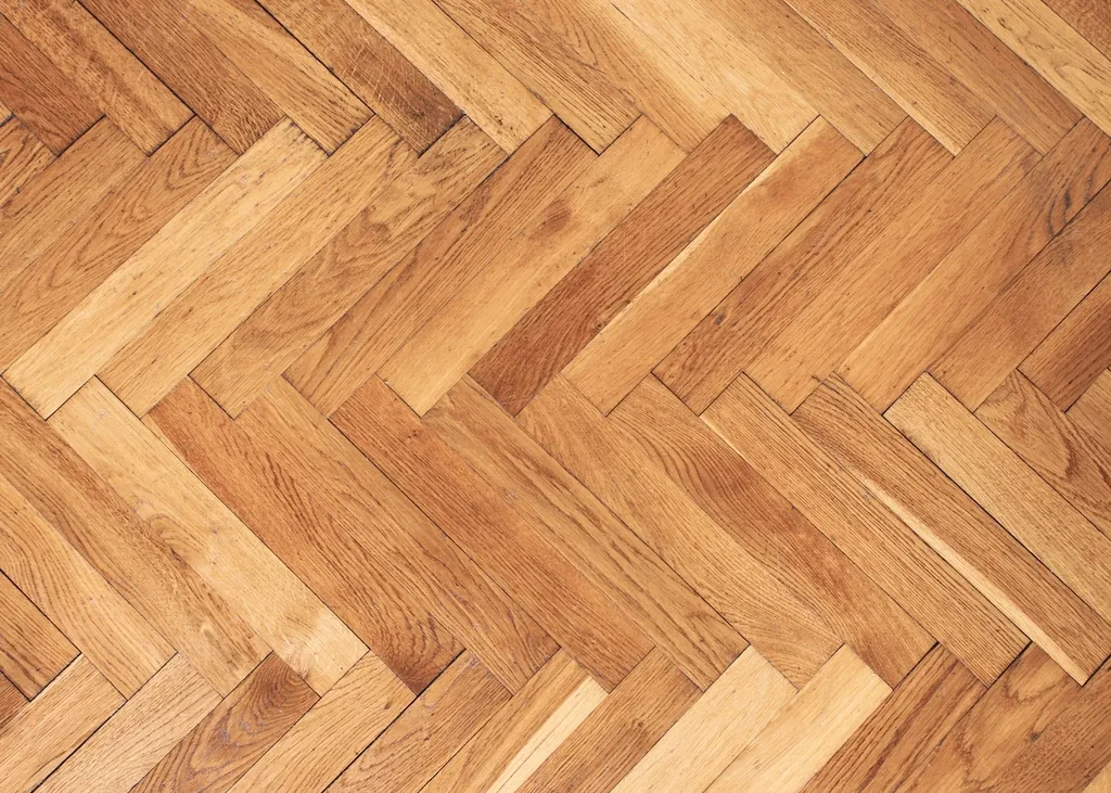 Herringbone hardwood floor in warm honey tones