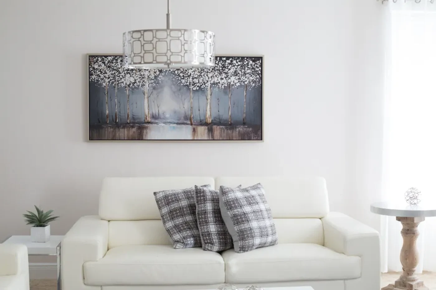 Bright living room with a white sofa and a pendant light